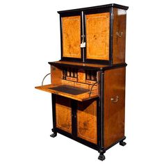 an old fashioned wooden desk with two doors on the top and bottom, sitting in front of a white background