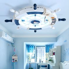 a bedroom with blue walls and ceiling fan in the middle, along with white furniture