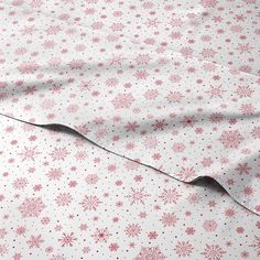 a white sheet with pink snowflakes on it