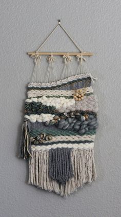 a wall hanging made out of yarn and wood