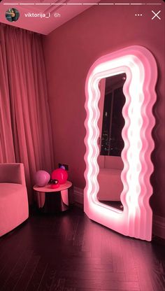 a pink room with a large mirror on the wall