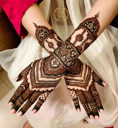 two hands with henna designs on them