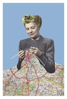 a woman is knitting on a map with pins in her hands and needles in her mouth