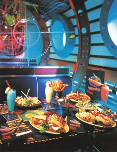 a table filled with plates of food and drinks