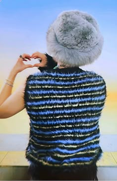 a woman sitting down with her back to the camera