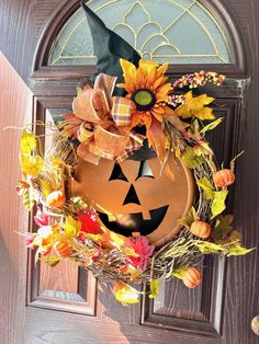 a door with a pumpkin shaped wreath on it