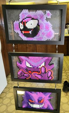 some pixel art is hanging on the wall in front of a mirror with an image of sonic