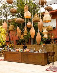 an outdoor bar with lots of hanging lights