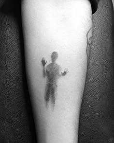 a black and white photo of a person's arm with a hand print on it