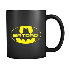 the batman logo on a black coffee mug with yellow lettering that reads batdad,