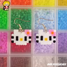 the earrings are made out of plastic beads and have sheeps on them in different colors