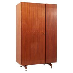 a tall wooden cabinet with two doors and wheels on the bottom, against a white background