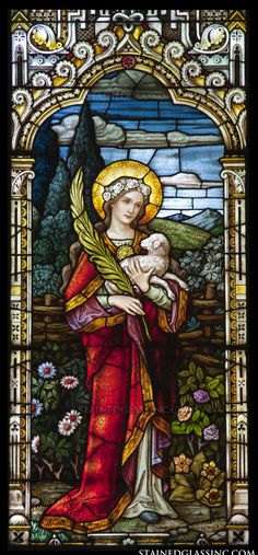 a stained glass window with a woman holding a baby