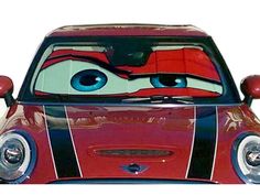 the front end of a red car with eyes painted on it