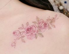 a woman's back tattoo with pink roses on her left shoulder and lower back