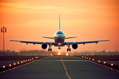 an airplane is taking off from the runway at sunset or dawn with its landing gear down