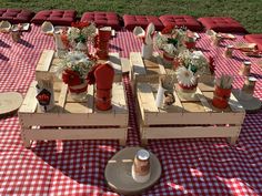 two wooden pallets sitting on top of a red and white checkered table cloth