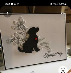 a handmade card with a black dog on it's side and the words sympathy written in red