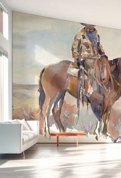 a living room with a large painting on the wall and two horses standing in front of it