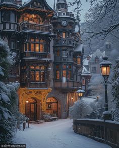 a large building with many windows and lights on it's sides in the snow