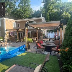 a backyard with an inflatable pool and patio furniture