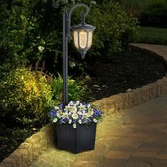 an outdoor lamp post with flowers in it