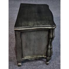 an old metal cabinet sitting on top of a carpeted floor