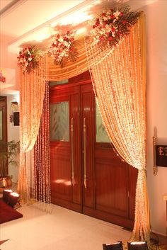 an entrance decorated with flowers and lights