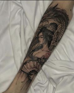 a woman with a dragon tattoo on her arm