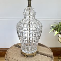 a clear glass vase sitting on top of a wooden table