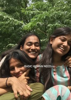 three young women are hugging each other in front of some trees and the words basic human needs