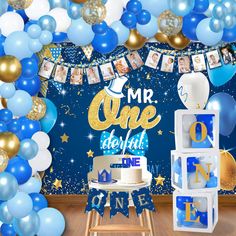 a blue and gold 1st birthday party with balloons, streamers, cake and decorations