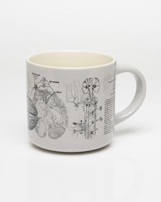 a white coffee mug with drawings on it