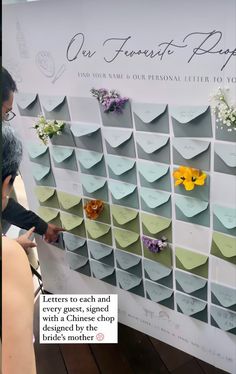 people are looking at a display with flowers on it