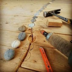 some rocks are laying on top of a wooden table next to a pair of scissors