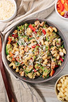 a pan filled with pasta and vegetables on top of a table