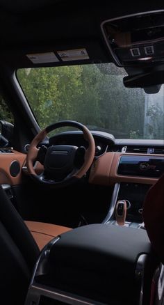 the interior of a vehicle with dashboard, steering wheel and center console in front of it