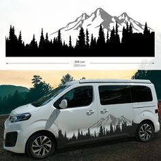 a white van parked in front of a mountain with trees on it's side