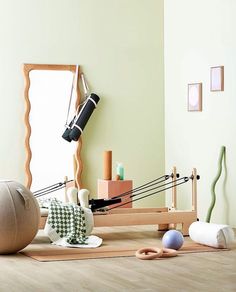 a room with various objects on the floor and a mirror in the corner above it