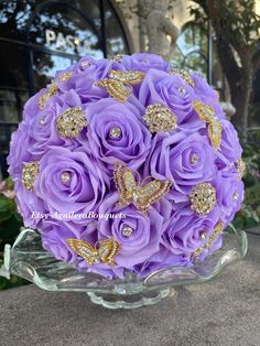 a bouquet of purple roses and gold butterflies