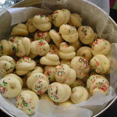 a pan filled with cookies and sprinkles sitting on top of a table