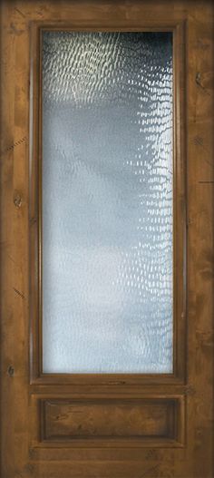 a close up of a wooden door with frosted glass on the front and side