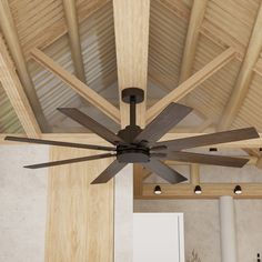 a ceiling fan with wooden blades in a room