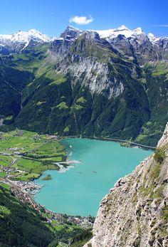 a mountain lake surrounded by lush green mountains