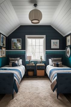 two beds in a room with blue walls and carpeted flooring, framed pictures on the wall