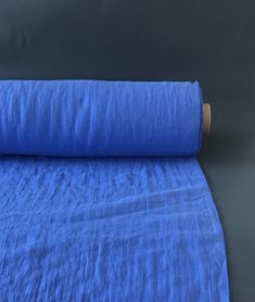 a roll of blue fabric sitting on top of a table