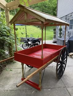 an old fashioned red wagon with a canopy