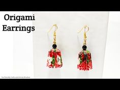 the earrings are decorated with red flowers and black beads