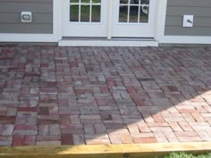 a brick patio in front of a house