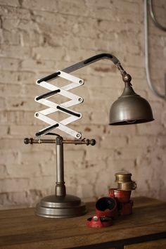 a desk lamp sitting on top of a wooden table